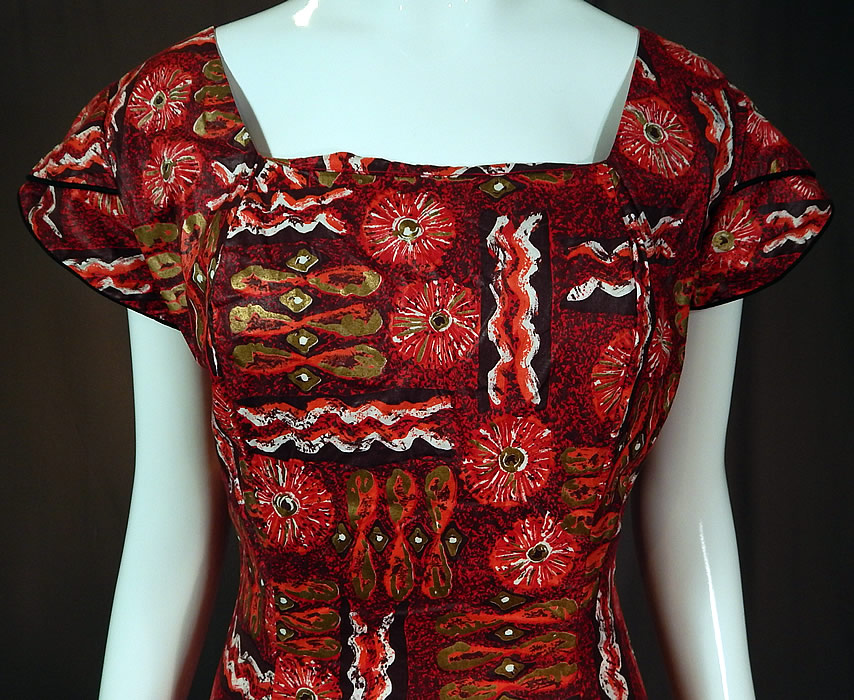 Vintage Kaulana By Perry Hawaiian Polynesian Print Red Cotton MuuMuu Maxi Dress
This retro Hawaiian muumuu style sheath, form fitting maxi dress is a long floor length with a flared bottom ruffle skirt, squared neckline, short cap sleeves, back zipper closure and is unlined. 
