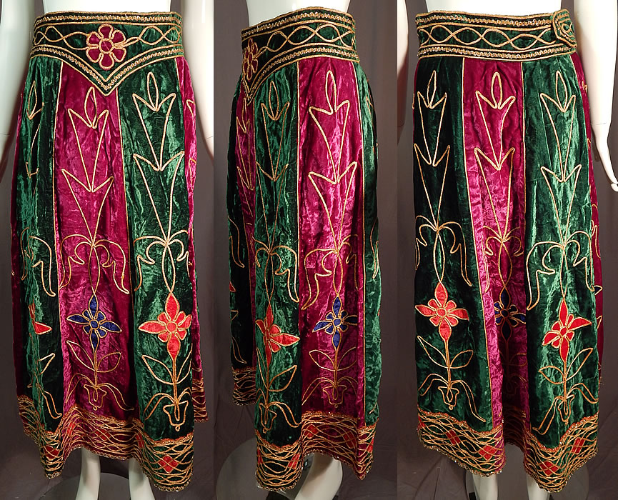 Vintage Indian Purple & Green Gold Embroidered Velvet Patchwork Maxi Skirt
This vintage Indian purple and green gold embroidered velvet patchwork maxi skirt dates from the 1970s. It is made of purple and green velvet fabrics with gold metallic raised embroidered trim done in a decorative patchwork design with red and blue velvet appliqu&eacute;d flowers.