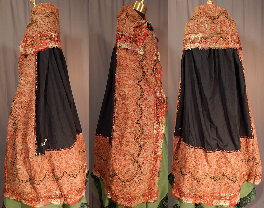 Victorian Antique Wool Signed Kashmir Paisley Shawl Collar Cloak Cape
This Victorian era antique wool signed Kashmir paisley shawl collar cloak cape dates from the 19th century. It is made of jacquard hand loomed woven wool done in strong bright vivid autumn fall colors, with the black wool center pieced on the back and signed by the weaver in a white hand embroidered stitching and a colorful floral leaf border edging the black square center. 