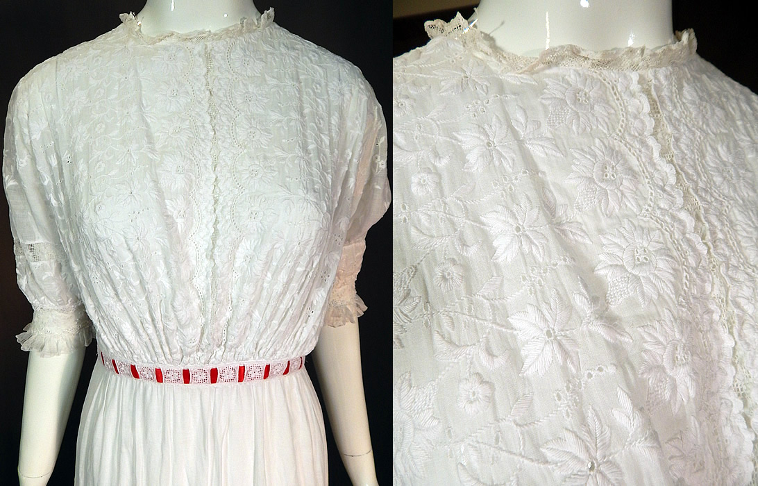 Edwardian White Cotton Batiste Floral Eyelet Embroidered Lace Lawn Dress Tea Gown
This exquisitely embroidered lawn dress is a long tea length, with a lace trim neckline, lace trimmed fitted cuffs short sleeves, a red ribbon accent woven through the waistband and skirt, tiny crochet button closures down the back and is lined only in the skirt with a cotton petticoat sewn inside. 