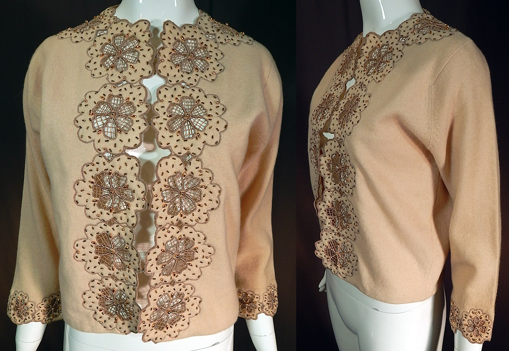 Vintage Vic & Vic Haute Couture Hong Kong Beaded Cutwork Cardigan Sweater
This vintage Vic & Vic Haute Couture Hong Kong beaded cutwork cardigan sweater dates from the 1960s. It is made of an ecru beige color lambswoo fabric, with embroidered outlined cutwork flowers and gold beaded accents. 