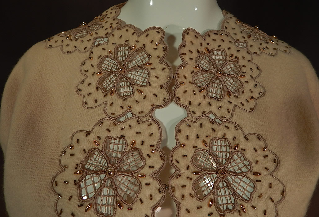 Vintage Vic & Vic Haute Couture Hong Kong Beaded Cutwork Cardigan Sweater
This lovely lacy cardigan sweater has sheer floral cutwork lace flowers trimming the front opening, neckline, cuffs, long full sleeves, fully lined and hook closures down the front.