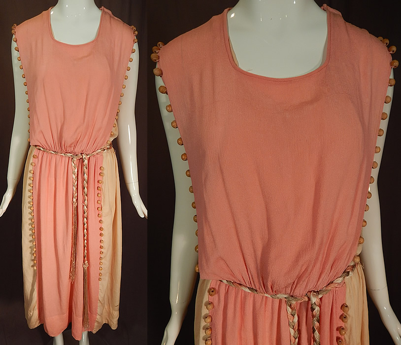 Vintage Grecian Goddess Pink Silk Crepe Wood Beaded Belted Tabard Tunic Dress
This vintage Grecian goddess pink silk crepe wood beaded belted tabard tunic dress dates from the 1920s. It is made of a pink silk crepe de chine fabric with a natural polished wood beading trim along the side edging and a pale pink blush color silk crepe de chine lining.