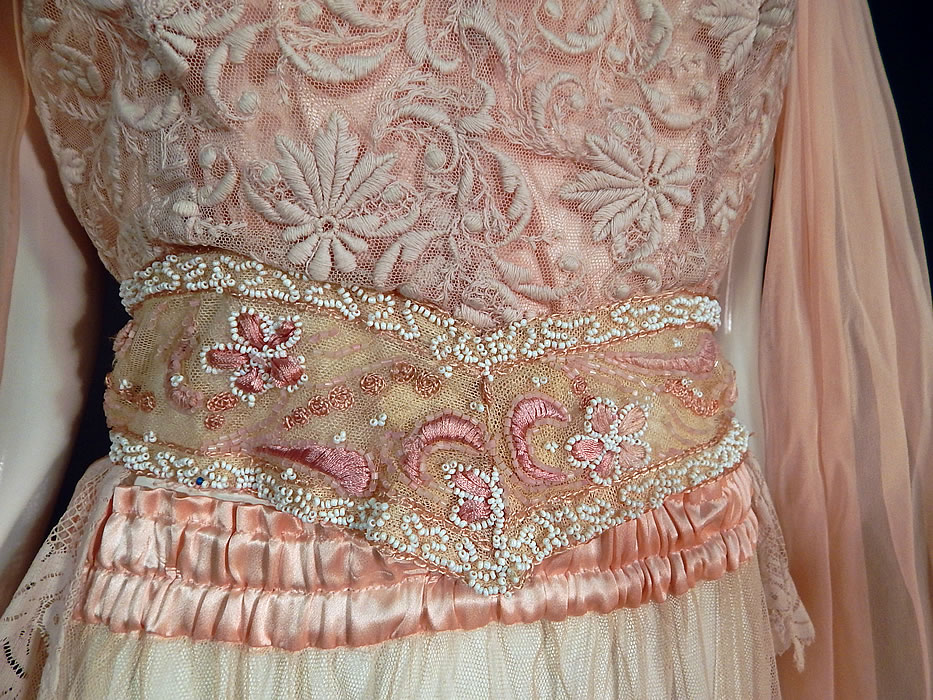 Vintage Pink Net Tambour Embroidery Lace Dress Kimono Sleeve Blouse & Skirt
The top measures 17 inches long in the front, 30 inches long in the back, with a 38 inch bust, 26 inch waist and 48 inch long sleeve scarf panels. Included is a matching long floor length maxi skirt, with pink satin gathered elastic waist band and is sheer, unlined. 