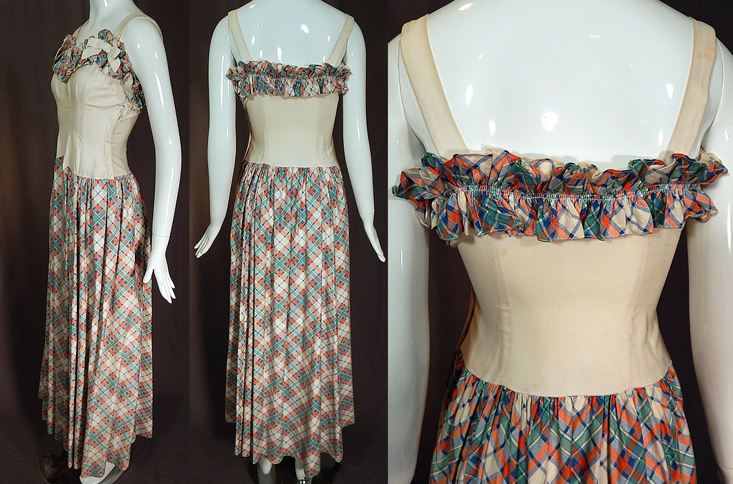 Vintage White Cotton Pastel Plaid Print Ruffle Flounce Bow Trim Maxi Dress
This stunning sundress long floor length maxi dress has a ruffle flounce trim sweetheart neckline, with white bow trim shoulder straps, a fitted bodice, long full plaid skirt, side hook closures and is unlined. 
