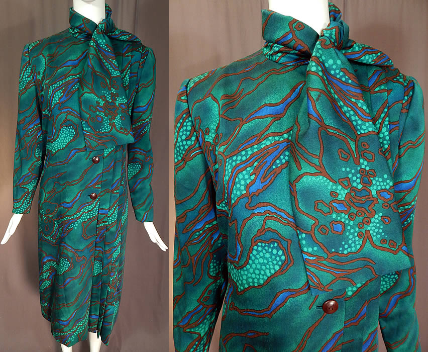 Vintage Pauline Trigere Green Abstract Stained Glass Floral Print Neck Scarf Dress
This vintage Pauline Trigere green abstract stained glass floral print neck scarf dress dates from the 1980s. It is made of a green wool cotton blend fabric, with a blue and brown abstract stained glass style floral print design. 
