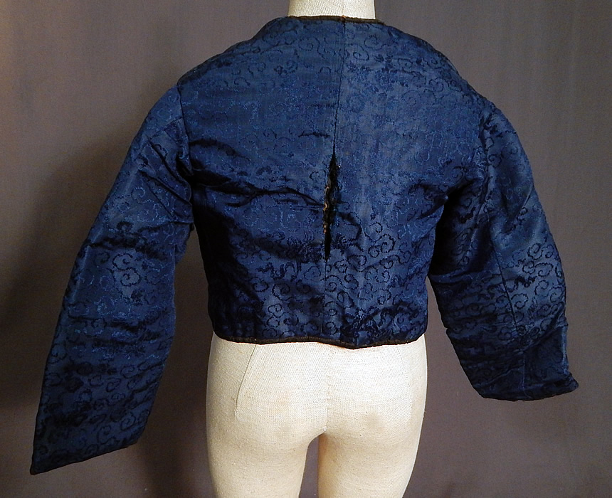 Victorian Antique Chinese Blue Silk Damask Brocade Quilted Boys Child Coat Jacket
This child's Chinese coat jacket has a Western style, with a short cropped length, tailored, form fitting, long full sleeves, black silk trim edging, with blue crochet button closures down the front and is fully lined in a quilted black silk fabric with cotton batting inside for warmth.
