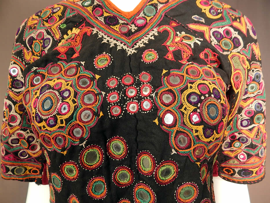 Vintage Indian Gujarati Kutch Work Embroidered Mirror Choli Boho Blouse Top
This stunning traditional handmade hand embroidered fitted, short cropped choli boho blouse top has an open back with two adjustable back tie strap closures at the neck, waist and is fully lined in a green and yellow floral print cotton fabric inside. The top measures 19 inches long, with a 34 inch bust and 26 inch waist.
