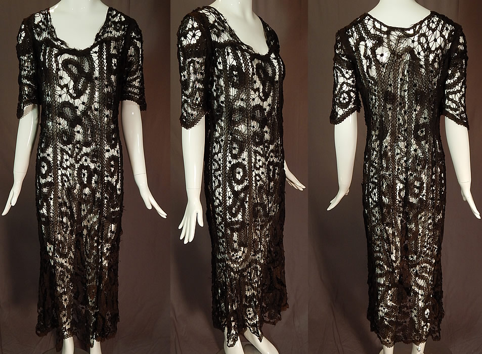 Vintage Antique Handmade Sheer Black Battenburg Bobbin Tape Lace Dress
This vintage antique handmade sheer black battenburg bobbin tape lace dress dates from 1920. It is hand made of a sheer fine black filmy linen tape lace, joined by bobbin made braids and thread bars creating an abstract patchwork effect design pattern. 