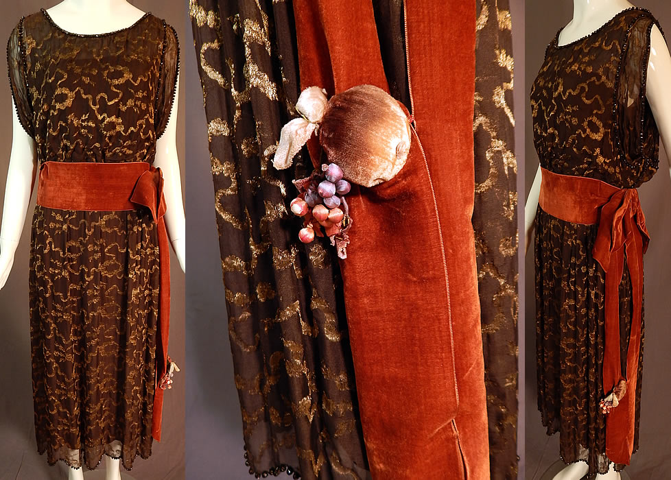 Vintage Art Deco Brown Silk Gold Lam&eacute; Lame Beaded Belted Flapper Dress
This vintage Art Deco brown silk gold lam&eacute; beaded belted flapper dress dates from the 1920s. It is made of a dark brown sheer silk chiffon gold lam&eacute; fabric with gold metallic threads woven through in a wavy ribbon, floral garland wreath design and black faceted glass beads edging the top and scalloped bottom skirt hem.