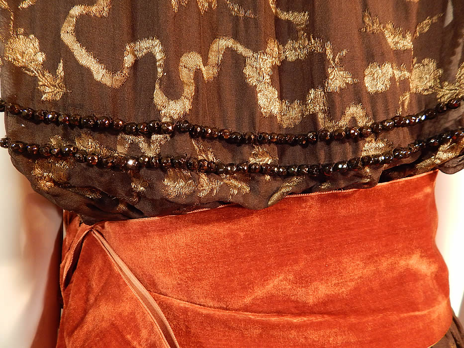 Vintage Art Deco Brown Silk Gold Lame Beaded Belted Flapper Dress Lam&eacute;
The dress measures 48 inches long, with a 36 inch bust and 26 inch waist. It is in good condition, with only a few loose missing beads and tiny holes on the inside silk lining. This is truly a wonderful piece of Art Deco wearable textile art! 