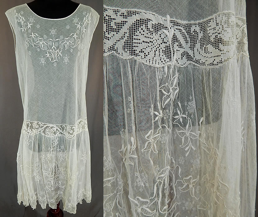 Vintage White Tulle Net Snowflake Embroidered Filet Lace Drop Waist Chemise Dress
This vintage white tulle net snowflake embroidered filet lace drop waist chemise dress dates from the 1920s. It is made of a white sheer tulle net lace fabric with a woven snowflake pattern design, raised padded satin stitch embroidery work and a filet lace trim waist insert. This lovely lace, loose fitting chemise style drop waist dress is sleeveless, with a short full skirt, scalloped edge hemline and is sheer, unlined.