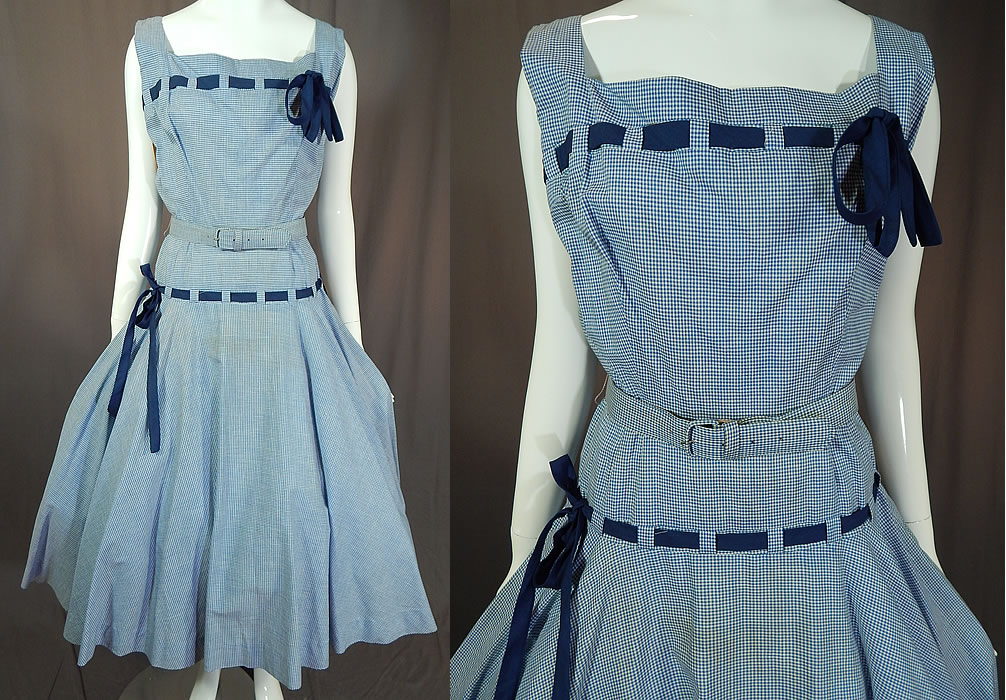 Vintage Henry Rosenfeld Blue White Cotton Check Gingham Belted Circle Skirt Dress NWT
This vintage Henry Rosenfeld blue and white cotton check gingham belted circle skirt dress dates from the 1950s. It is made of a blue and white cotton checkered gingham fabric, with navy blue bow trim woven through the front neckline and around the hips.