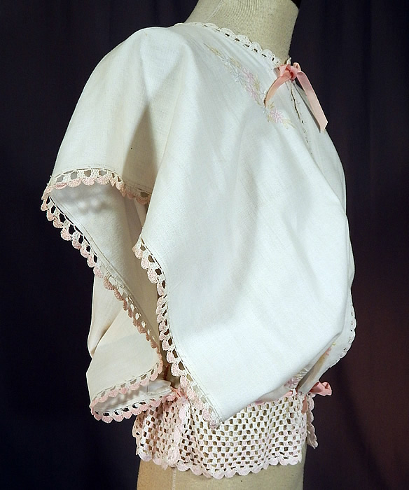 Edwardian White Linen Pastel Embroidered Crochet Lace Combing Bed Jacket
This beautiful boudoir bed combing jacket is loose fitting, with wide open sides, an open front with a pink ribbon tie closure at the neck and drawstring waist. 