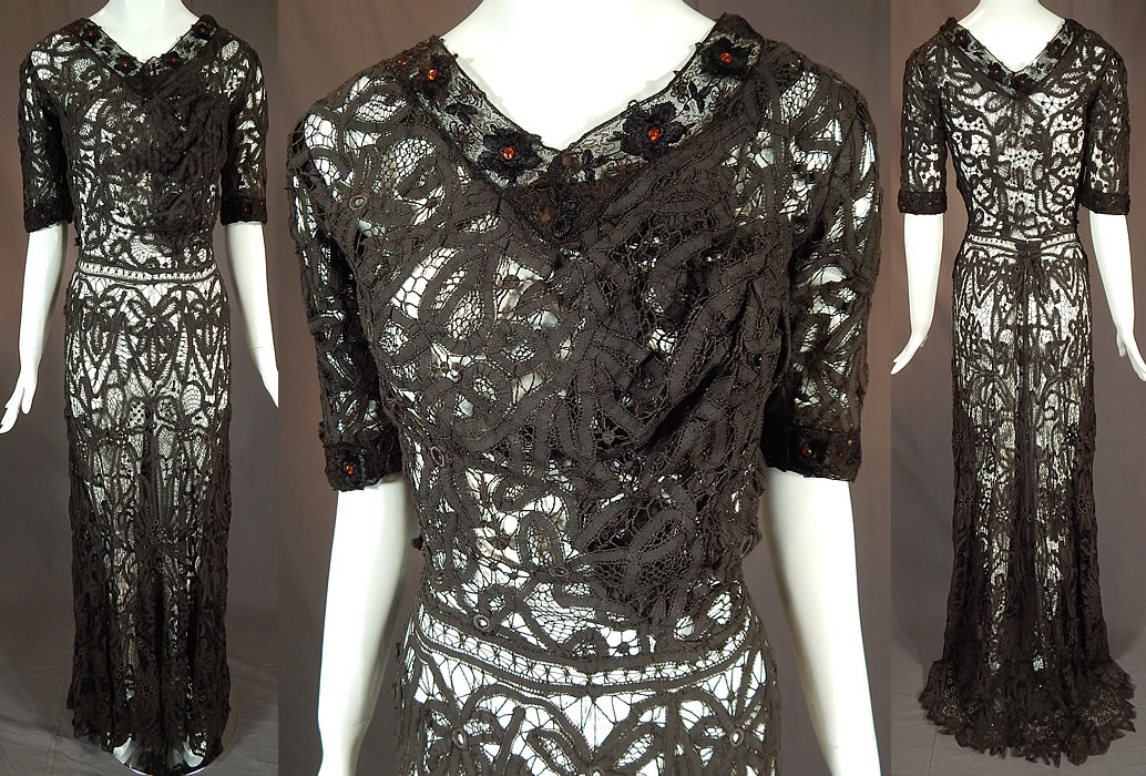 Edwardian Antique Black Battenburg Tape Lace Amber Beaded Gown Dress
This vintage Edwardian era antique black battenburg tape lace amber beaded gown dress dates from 1905. It is made of a sheer fine black filmy linen tape lace, joined by bobbin made braids and thread bars creating an abstract spiral scrolling floral design pattern. 
