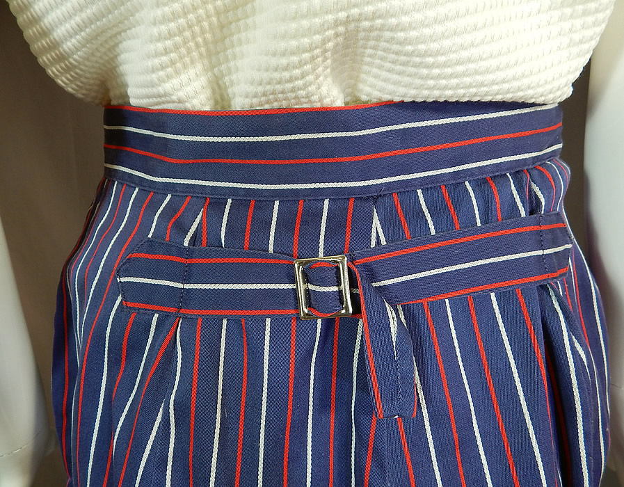 Vintage Jantzen Womens Sportswear Red White Blue Golf Outfit Shirt Shorts
This womens sportswear golfing outfit has a sleeveless pull over style shirt, with fold over collar, button closure at the neck and is unlined. The top measures 22 inches long, with a 38 inch bust and 36 inch waist. There is a "Jantzen Women's" label size Large tag sewn inside. There are striped bermuda shorts, with an adjustable belted buckle back strap, side pockets and a fitted waistband with button, front zipper closures.
