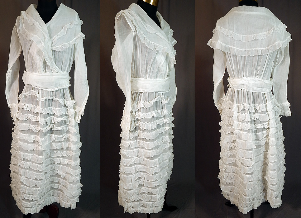 Edwardian White Cotton Organdy Ruffled Fichu Belted Dress Tea Gown
This vintage Edwardian era white cotton organdy ruffled fichu belted dress tea gown dates from 1915. It is made of a sheer white cotton organdy fabric with layered rows of ruffles on the skirt. 