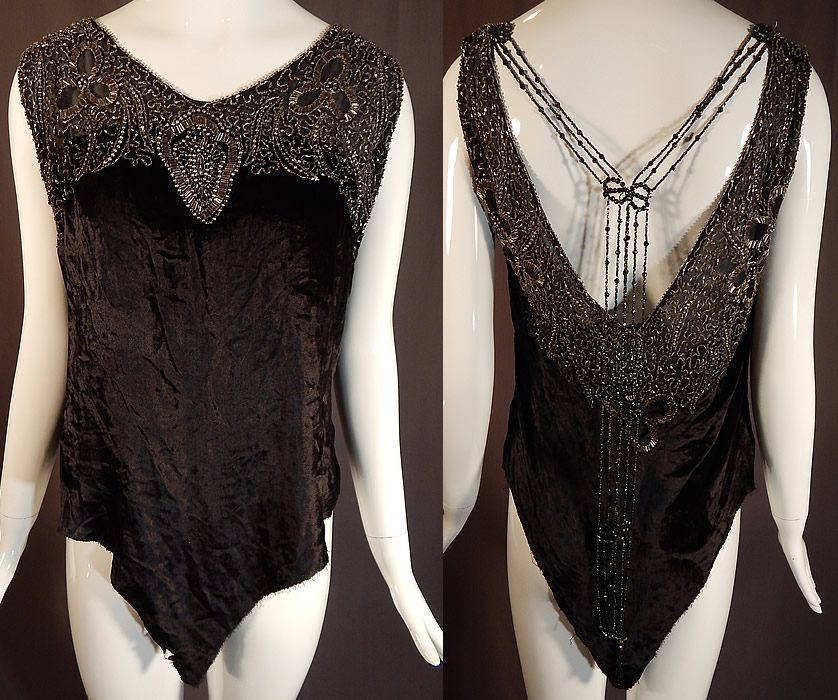 Vintage Art Deco Black Velvet Silver Studded Beaded Fringe Flapper Blouse Top
It is made of a black silk velvet fabric, with steel gray, crystal and silver metal studs beadwork done in an abstract scrolling spiral floral leaf design along the yoke neckline backed on a black sheer silk chiffon fabric and beaded fringe hanging down the back.