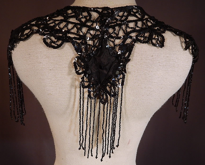 Victorian Black Silk Sequin Jet Beaded Fringe Shawl Collar Dress Trim
This beautiful beaded shawl collar dress trim has an ornamental shoulder epaulette style, with scalloped edging and is sheer, unlined. The collar measures 10 inches long with fringe and is 30 inches wide. 