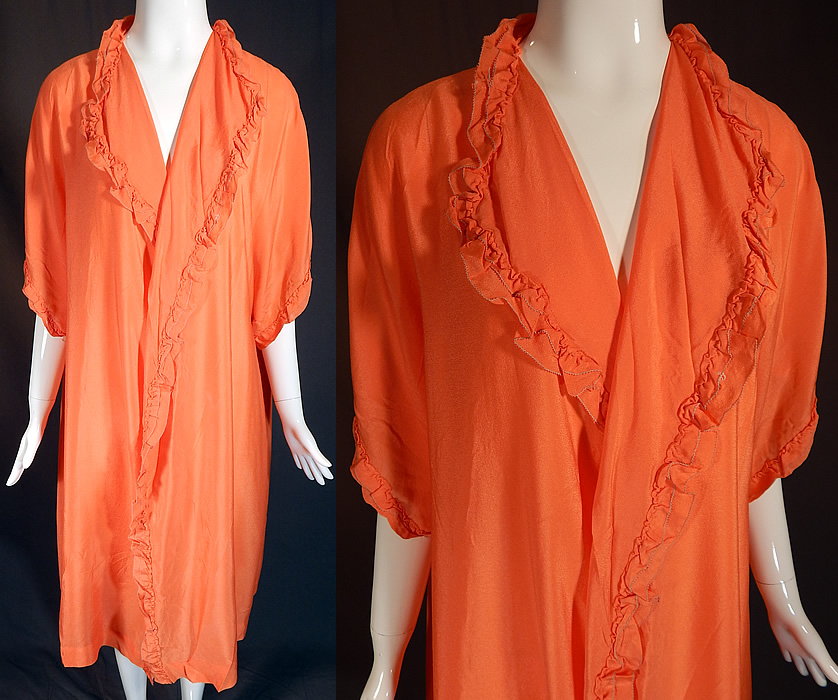 Vintage Orange Silk Ruffle Boudoir Lingerie Flapper Peignoir Dressing Gown Robe
This vintage orange silk ruffle boudoir lingerie flapper peignoir dressing gown robe dates from the 1920s. It is made of a orange silk fabric, with matching ruched ruffle trim edging. This lovely lingerie peignoir dressing gown robe is loose fitting, with a fold over lapel collar, 3/4 length sleeves, an open front with no closure and is unlined. 