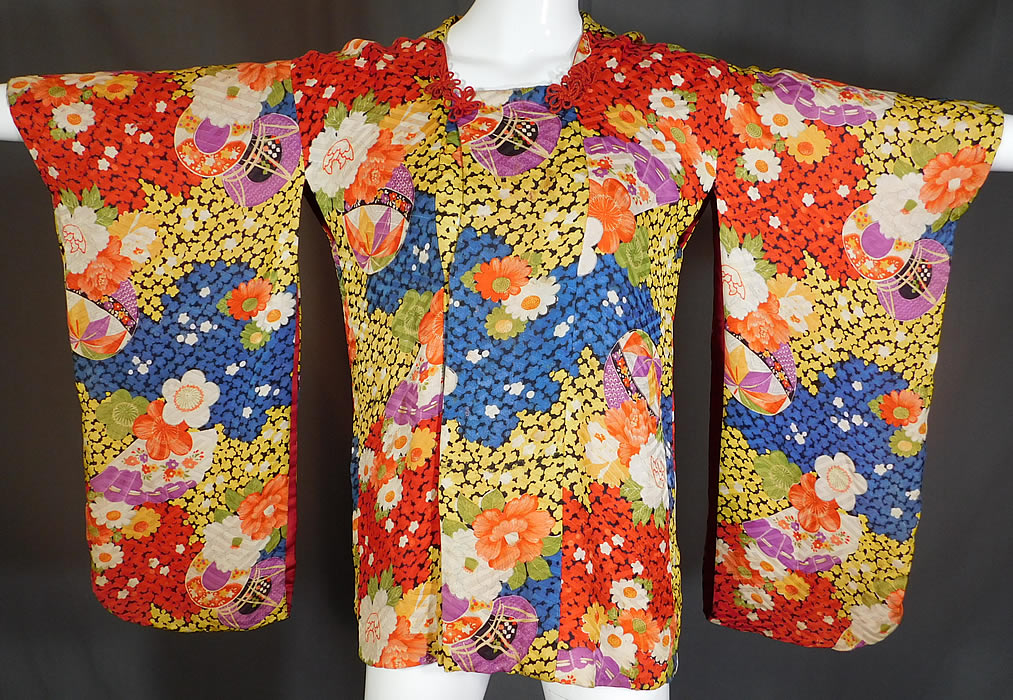 Vintage Japanese Colorful Floral Fan Silk Screen Haori Kimono Robe Jacket
This unique ceremonial coming of age Japanese haori kimono robe short jacket style overcoat would have been worn to protect the longer kimono underneath and has a quilted padded silk fabric back collar, long swinging kimono sleeves, red toggle snap closures on the front and is fully lined.