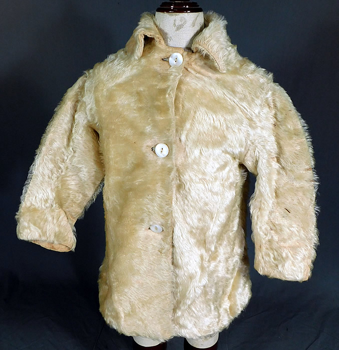 Victorian Childrens Curly White Mohair Fur Winter Coat & Cap Hat
This charming child's warm winter outfit includes a coat, with fold over collar, long sleeves, mother of pearl button closures and is fully lined in a cotton fabric. The coat measures 18 inches long, with a 24 inch chest, 18 inch waist, 12 inch long sleeves and a 10 inch back. Included is a matching fabric cap hat fully lined. 