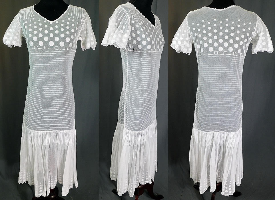 Vintage Polka Dot Embroidered White Tulle Net Pleated Shift Drop Waist Dress
This vintage polka dot embroidered white tulle net pleated shift drop waist dress dates from the 1920s. It is made of a white sheer tulle net fabric, with pleating and polka dot embroidery work designs along the top and bottom skirt.