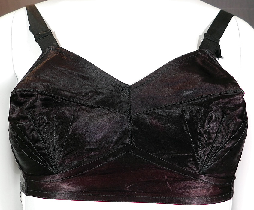 Vintage Quest-Shon Mark Black Silk Satin Stitched Cup Conical Cone Brassiere Bullet Bra	
It is made of a black silk satin fabric with decorative mermaid fin, sea shell stitching conical cone shape cups. 