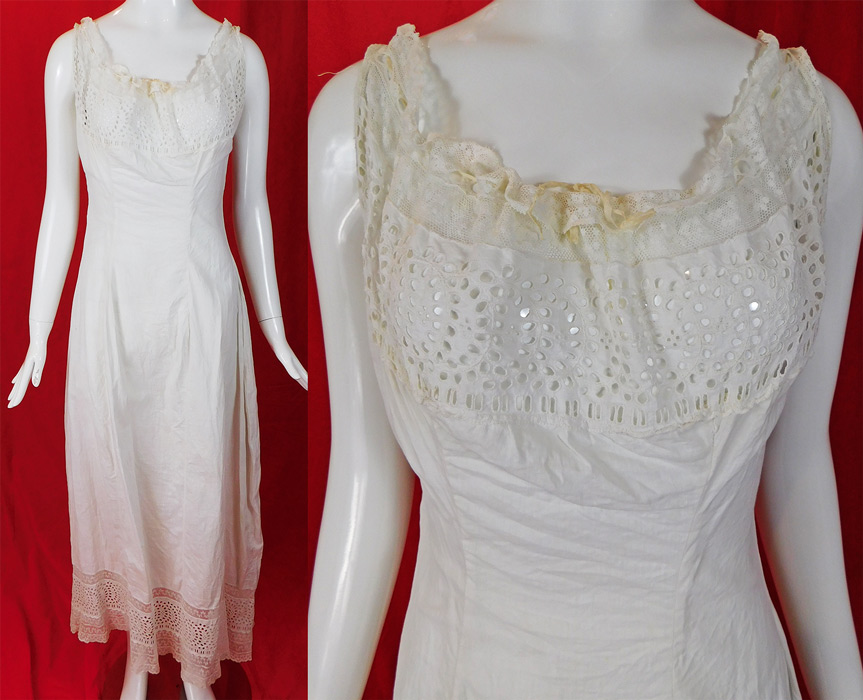 Victorian White Cotton Eyelet Cutwork Broderie Anglaise Lace Full Slip Dress
This antique Victorian era white cotton eyelet cutwork broderie anglaise lace full slip dress dates from 1900. It is made of a white cotton fabric, with broderie anglaise whitework needlework, eyelet cutwork and lace trim edging. This lovely lace lingerie undergarment long full length slip dress has a squared lace trim cream silk ribbon adjustable drawstring neckline sleeveless top with a lace trimmed hemline, button closures down the back (missing one button) and is unlined. 