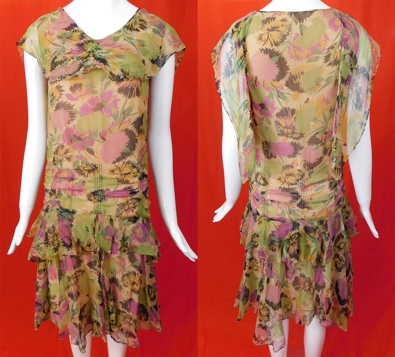 Vintage Floral Pastel Print Silk Chiffon Smocking Shawl Collar Drop Waist Dress
This pretty pastel Gatsby garden party dress is loose fitting, with a drop waist, sleeveless, scalloped shawl collar capelet front with back drape scarf, ruffled tiered skirt and is fully lined with a built in pink cotton slip lining sewn inside.