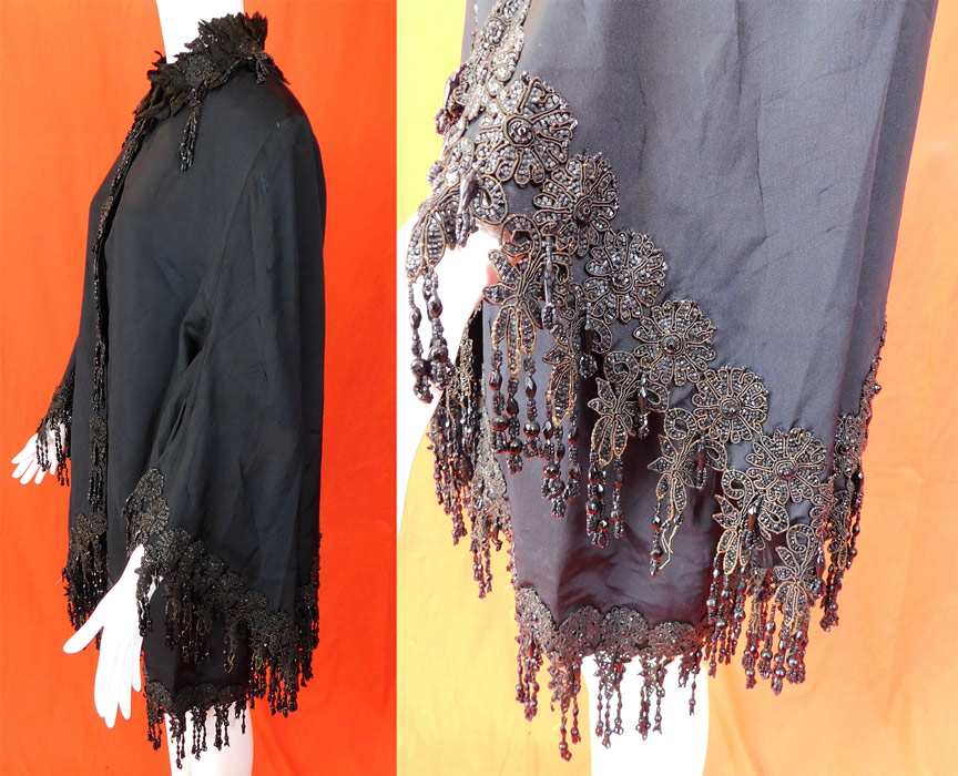 Victorian Black Silk Jet Beaded Fringe Tassel Trim Dolman Mantle Cloak Cape
This antique Victorian era black silk jet beaded fringe tassel trim dolman mantle cloak cape dates from 1880. It is made of a heavy black silk grosgrain taffeta fabric, with black jet beaded applique floral fringe tassel trim along the bottom edging, collar, cuffs and front opening.