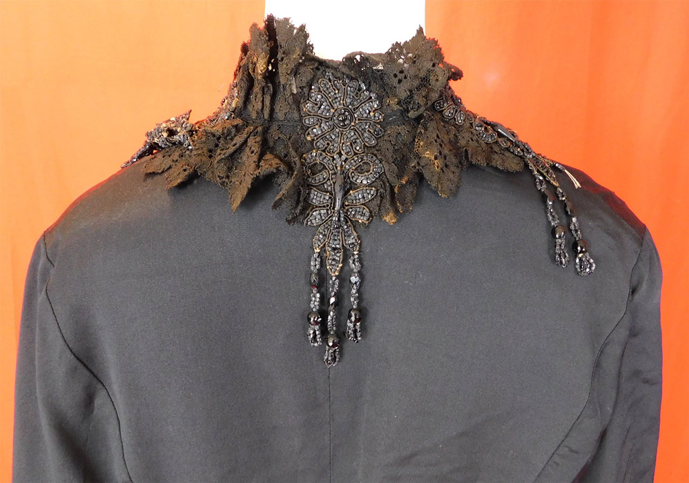 Victorian Black Silk Jet Beaded Fringe Tassel Trim Dolman Mantle Cloak Cape
It is in fair as-is condition, needing some restoration, with several small frays, splits scattered on the silk fabric, a small frayed hole on the shoulder, some discoloration fading on the black lace collar trim and some loose, missing beads (see close-ups). This is truly a wonderful piece of antique Victoriana wearable art! 