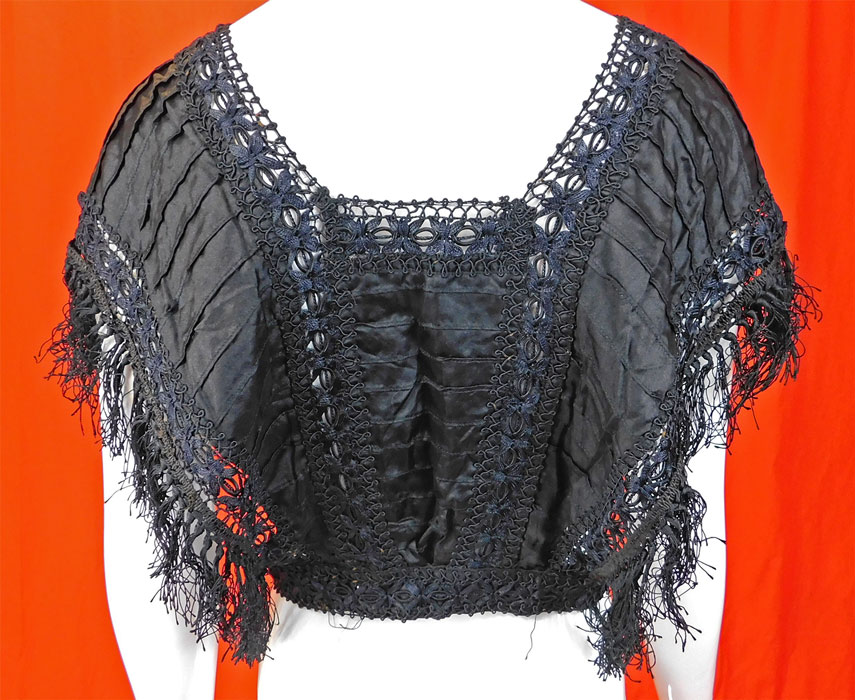 Victorian Black Silk Ruched Pleated Lace Fringe Trim Blouse Bodice Tabard Top
It is in good condition, with only some areas of loose fringe trim. This is truly a wonderful piece of antique Victoriana wearable art! 