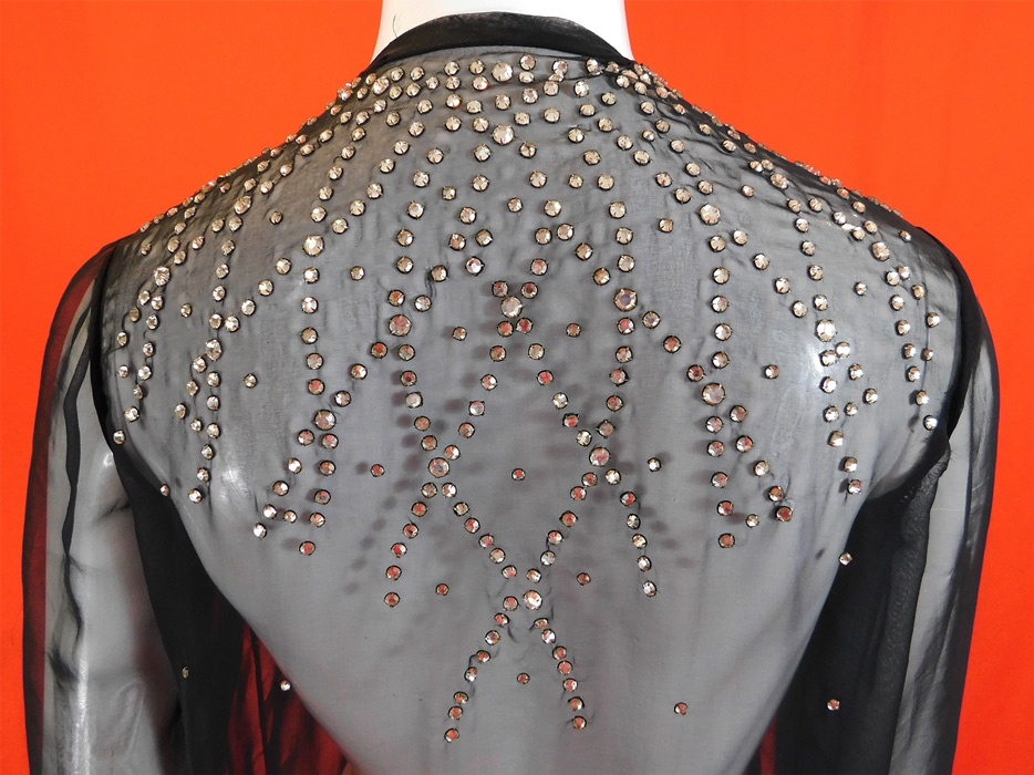Vintage Art Deco Style Sheer Black Rhinestone Beaded Glitzy Evening Coat Jacket
This vintage Art Deco style sheer black rhinestone beaded glitzy evening coat jacket dates from the 1940s.