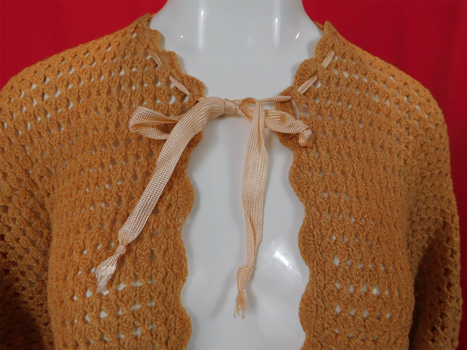 Edwardian Pink Hand Knit Crochet Wool Ribbon Morning Robe Bed Jacket Cape
This pretty pink morning robe combing bed jacket is a short mid length with a loose fitting poncho cape style, uneven handkerchief hemlines, with short dolman sleeves, an adjustable drawstring ribbon tie front neck closure and is sheer, unlined. 