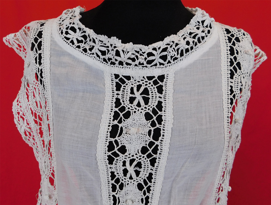 Edwardian White Cotton Batiste Cluny Torchon Bobbin Lace Tabard Tunic Top Dress
This antique Edwardian era white cotton batiste cluny torchon bobbin lace tabard tunic top dress dates from 1910. It is made of sheer white cotton batiste fabric with handmade cluny torchon bobbin lace trim with geometric patterns, spiderweb decorative designs. 