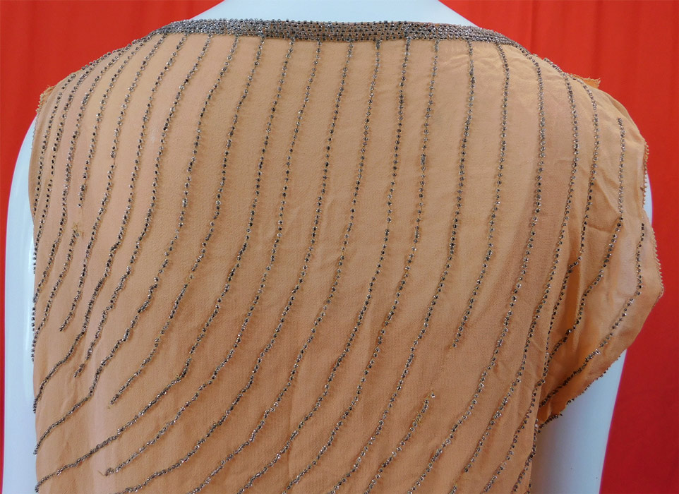 Vintage Art Deco Peach Silk Silver Beaded Grecian Goddess Style Flapper Dress
It is in good condition, with some loose missing beads in areas (see close-ups). 