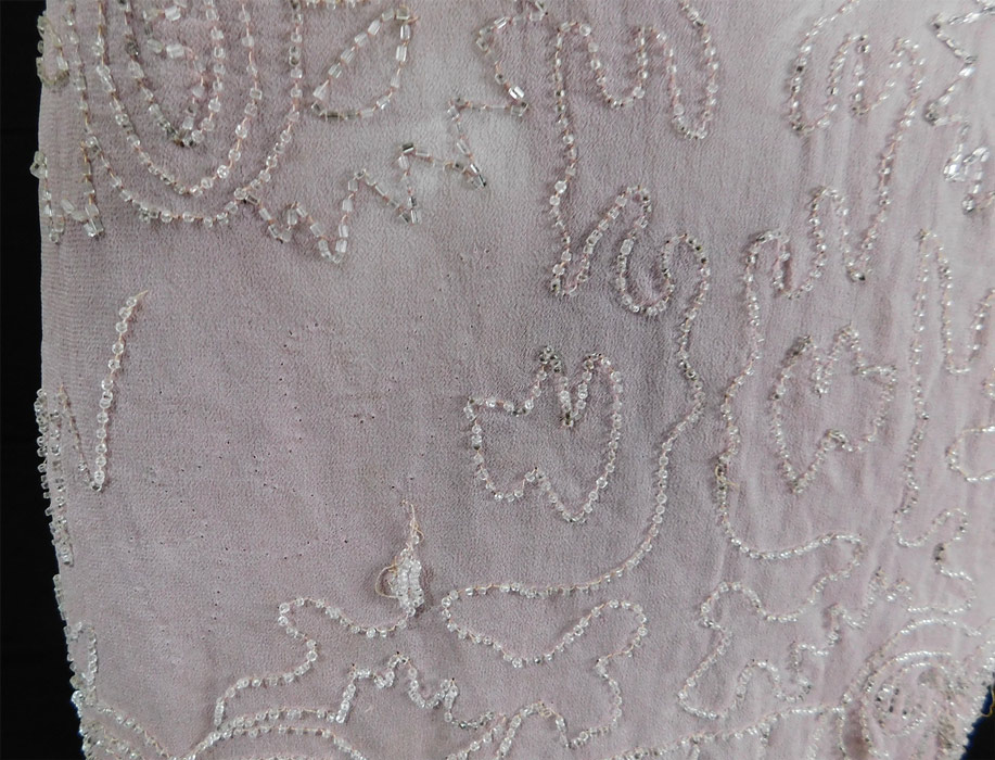 Vintage Art Deco Lilac Pink Sheer Silk Chiffon Crystal Beaded Flapper Dress
The dress measures 41 inches long, with a 34 inch bust, 34 inch waist and 38 inch hips.