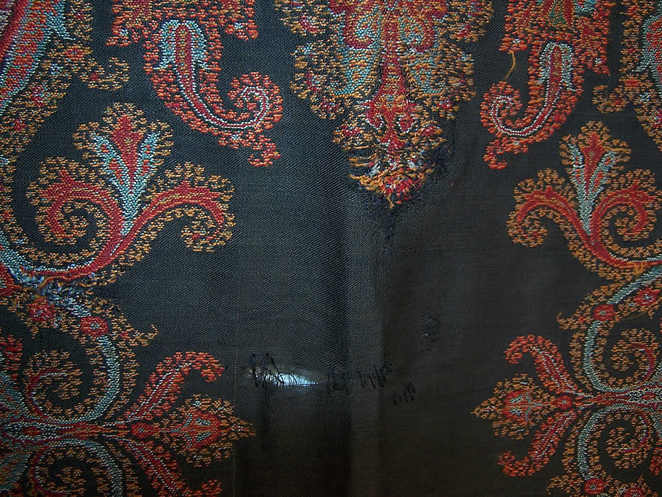 Victorian Antique Large Banquet Size Jacquard Hand Loom Wool Paisley Shawl extreme close up center a small frayed split in the center and several small rewoven repairs and patches near the center 