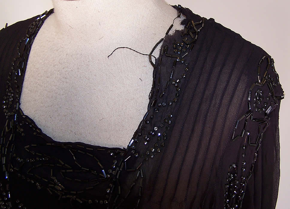 with some loose missing beading and fraying along the side neckline (see close-up). There is a frayed hole in the shoulder and back sleeve.