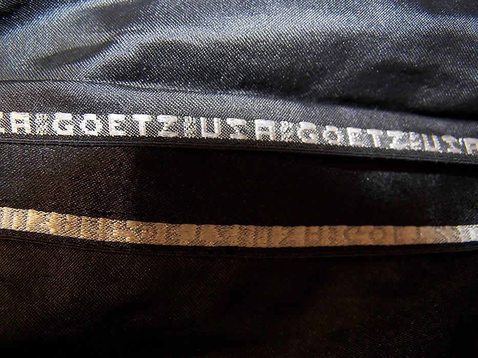 Vintage Art Deco Black Net Applique Sequin Beaded Blouse Flapper Tunic Top close up The fabric selvage is stamped inside "Goetz USA" and is weighted along the bottom hemline. 