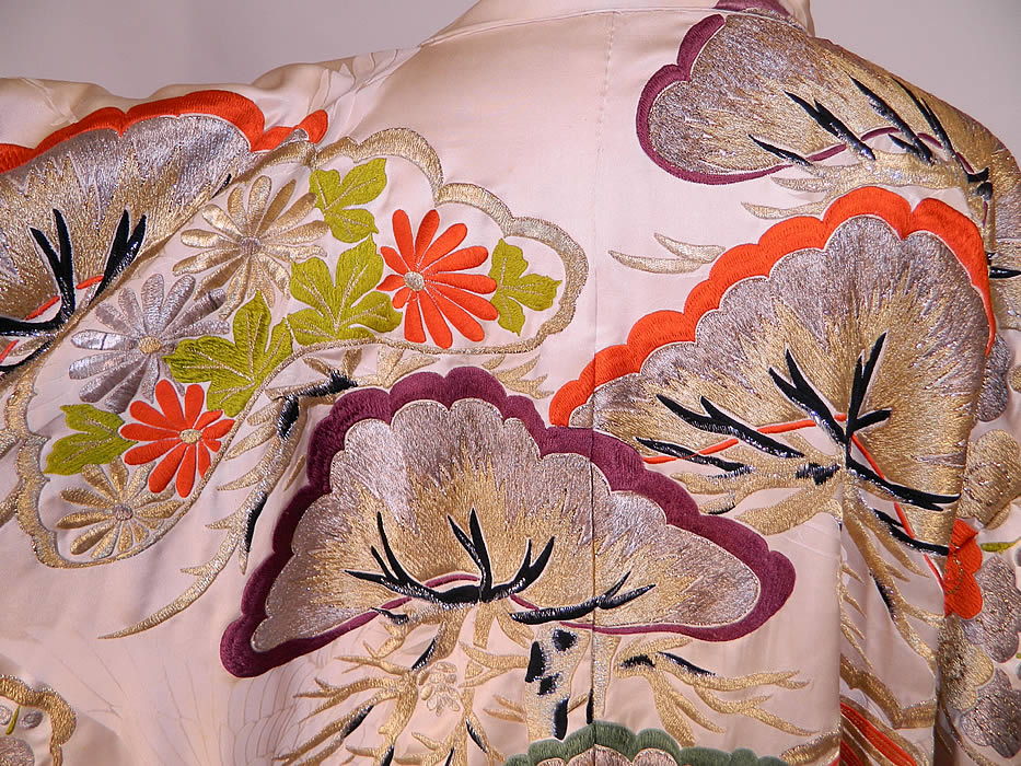 Vintage Japanese Crane Silk Brocade Pine Embroidered Uchikake Wedding Kimono. It is made of an off white cream color silk damask brocade woven crane fabric, with a colorful, gold and silver metallic thread raised padded satin stitch embroidered Japanese pine trees and flowers. 