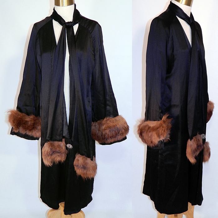Vintage Art Deco Black Silk Fur Trim Evening Cocoon Opera Coat Jacket. It is made of a black silk satin fabric, with fur trim sleeve cuffs and neck scarf ends. This exquisite evening opera coat has a long mid length loose fitting cocoon wrap style, with a long neck tie scarf, large silver steel cut beaded button closure and is fully lined in a chartreuse lime green yellow silk fabric inside. 