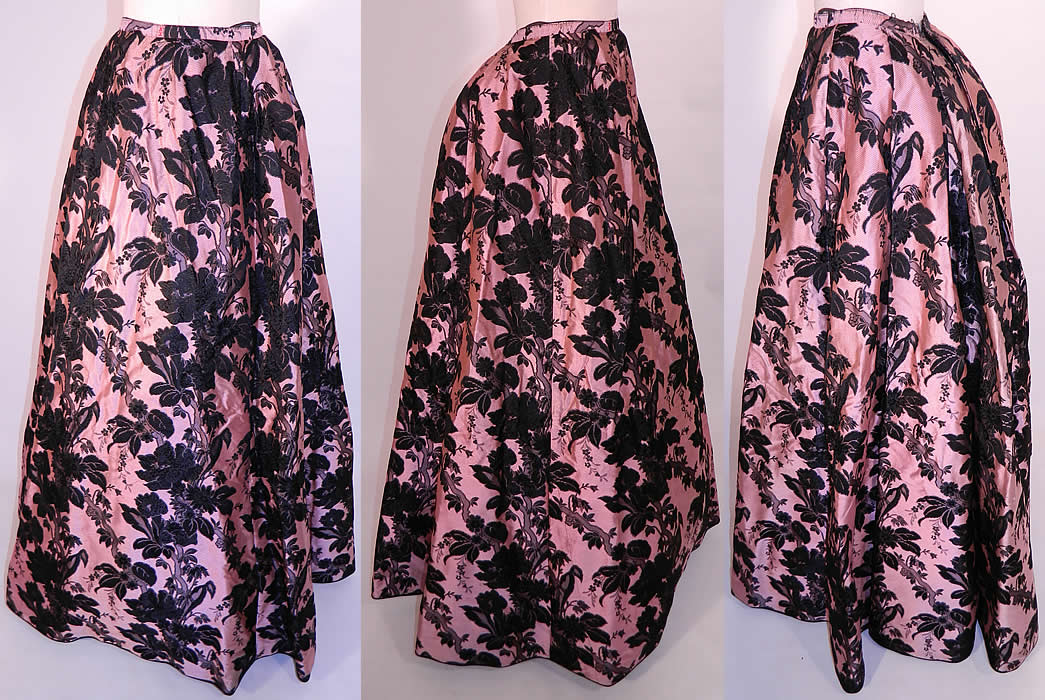 Victorian Pink & Black Floral Silk Damask Brocade Ball Gown Bustle Skirt. It is made of an extraordinary luxurious textured pink silk fabric, with a black silk damask brocade woven floral leaf branch pattern design