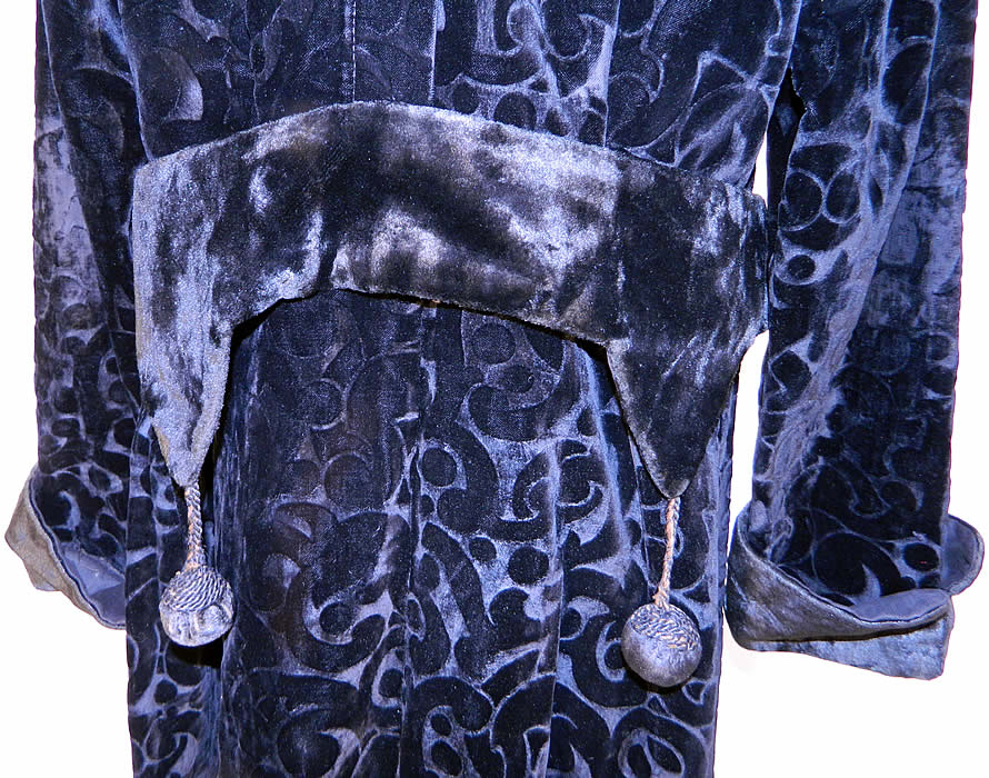 Edwardian Titanic Black Voided Velvet Winter Coat Evening Jacket. The coat measures 46 inches long, with 40 inch hips a 38 inch waist, 40 bust, 15 inch back and 24 inch long sleeves. It is in good condition, with only the arm hole seams having been resewn and is missing the top button closure at the neck. 