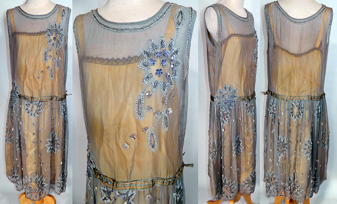 Vintage Blue & Yellow Silk Beaded Velvet Rosette Drop Waist Flapper Dress. It is made of a blue gray color sheer silk chiffon fabric, with blue & silver beaded floral star shape leaf applique's. There are tiny blue velvet rosette flowers and a blue & yellow silk ombre ribbon belted sash.