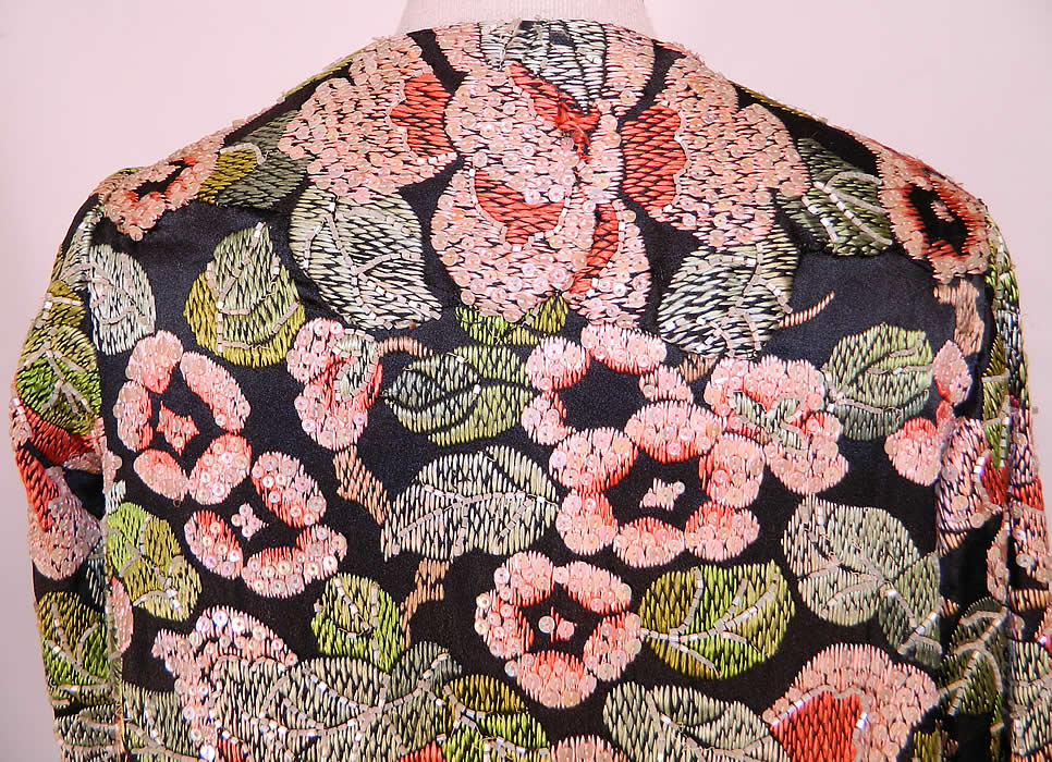 Vintage Art Deco Floral Silk Embroidered Sequin Beaded Long Coat Jacket. It is made of a black silk satin fabric, covered with colorful pastel hand embroidery work floral leaf designs accented with hand sewn sequins and beading. 