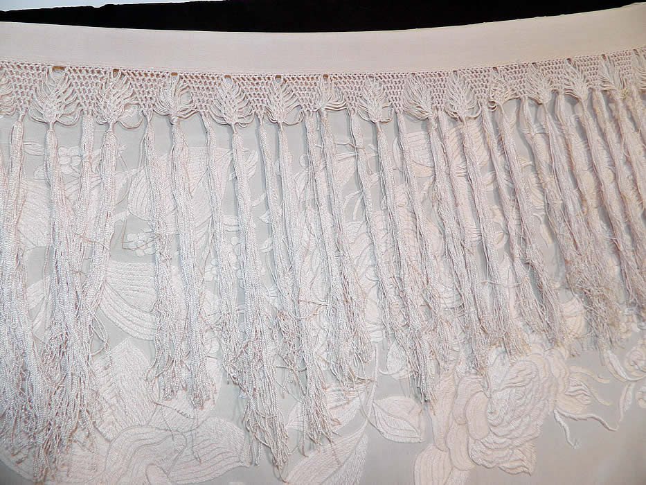 Antique Cream White Silk Embroidered Floral Canton Wedding Piano Shawl. color silk fringe which measures 9 inches long surrounding the entire shawl with rounded corners. The shawls fabric square measures 63 by 63 inches. This quality made Manton Canton Chinese Cantonese style Spanish Flamenco shawl would have been appropriate for a church wedding or other ceremonial occasions.