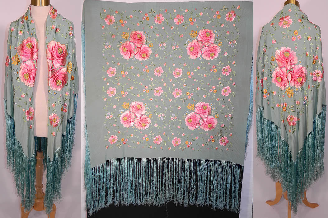 Antique Light Blue Silk Pink Floral Embroidered Fringe Boho Piano Shawl. It is made of a light blue silk fabric, with machine done raised padded satin stitch embroidered pink pastel flowers, yellow accents and green vine leaf designs.