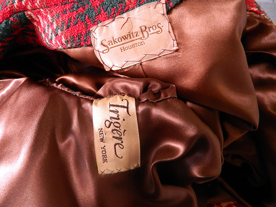 Vintage Pauline Trigere Red Green Houndstooth Plaid Wool Coat Swing Jacket. There is a "Trig&eacute;re" designer label and a "Sakowitz Bros. Houston" department store label sewn inside. The coat measures 46 inches long, with 44 inch hips, a 44 inch waist, 44 inch bust, 15 inch back and 26 inch long sleeves.
